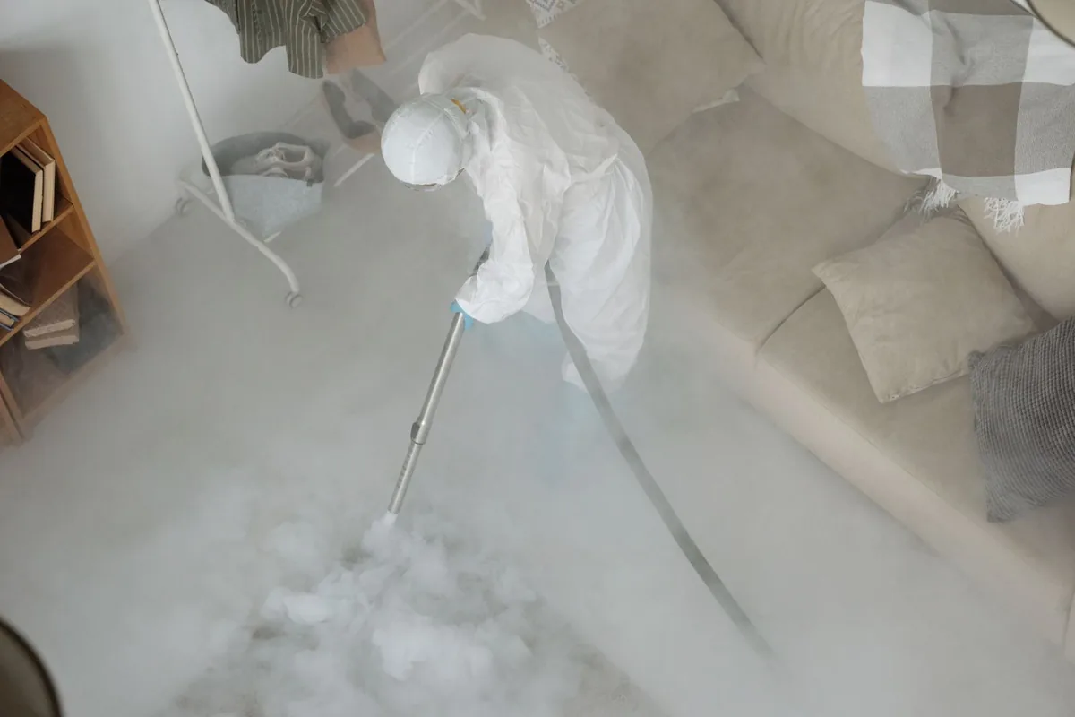 Biohazard cleanup technician in protective equipment, Somerville, MA
